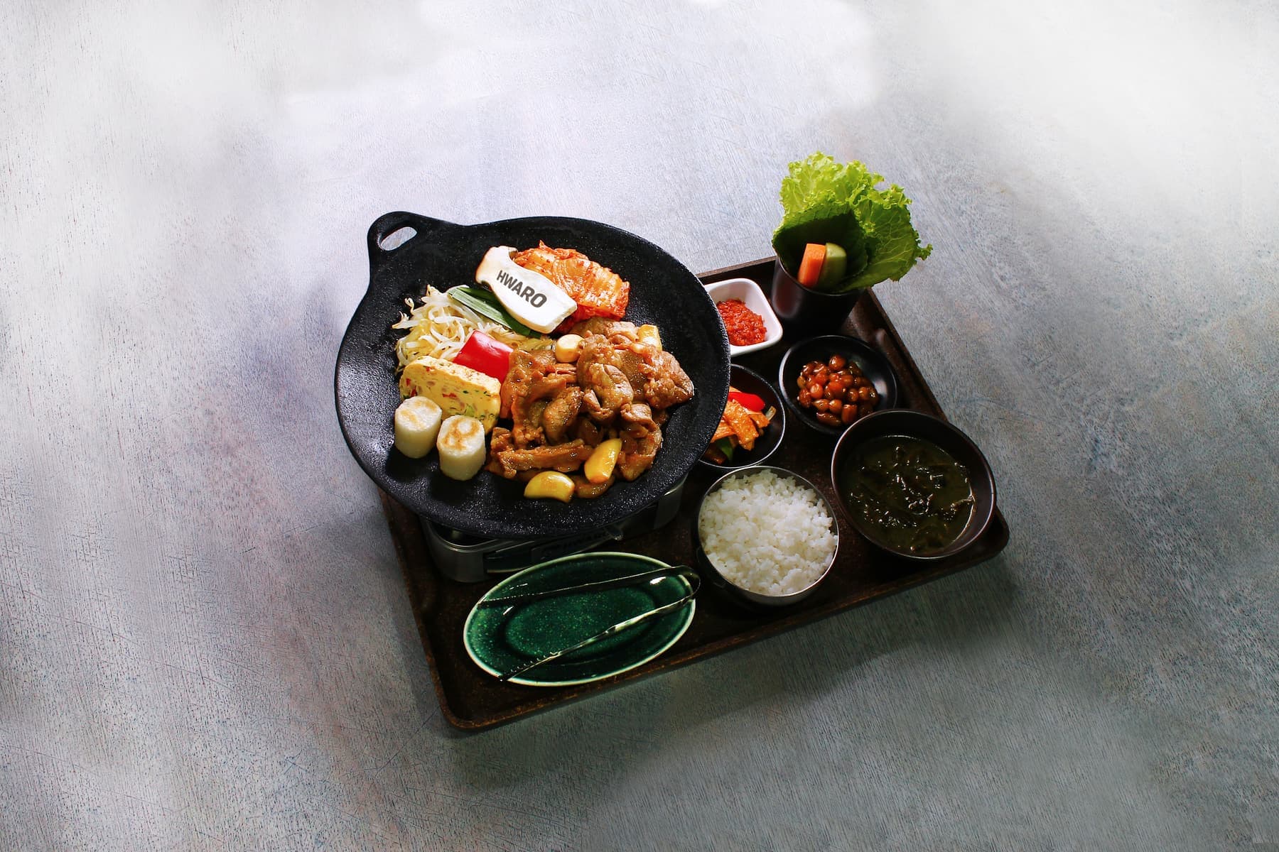 Dwaeji Bulgogi Griddle BBQ Set at Hwaro with banchan, rice and seaweed soup