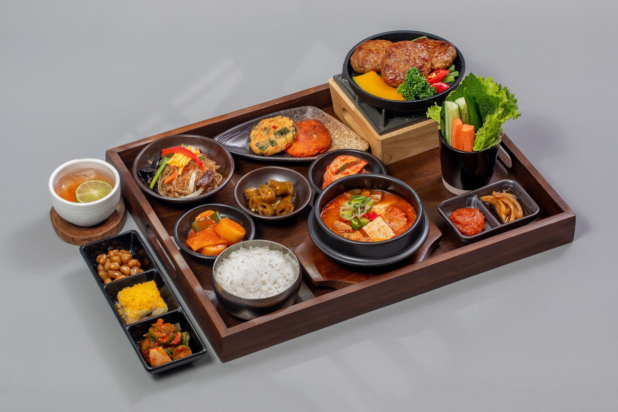 Tteokgalbi 3 Grill Set tray at The Bibimbab with japchae, jeon, stew, rice and banchan