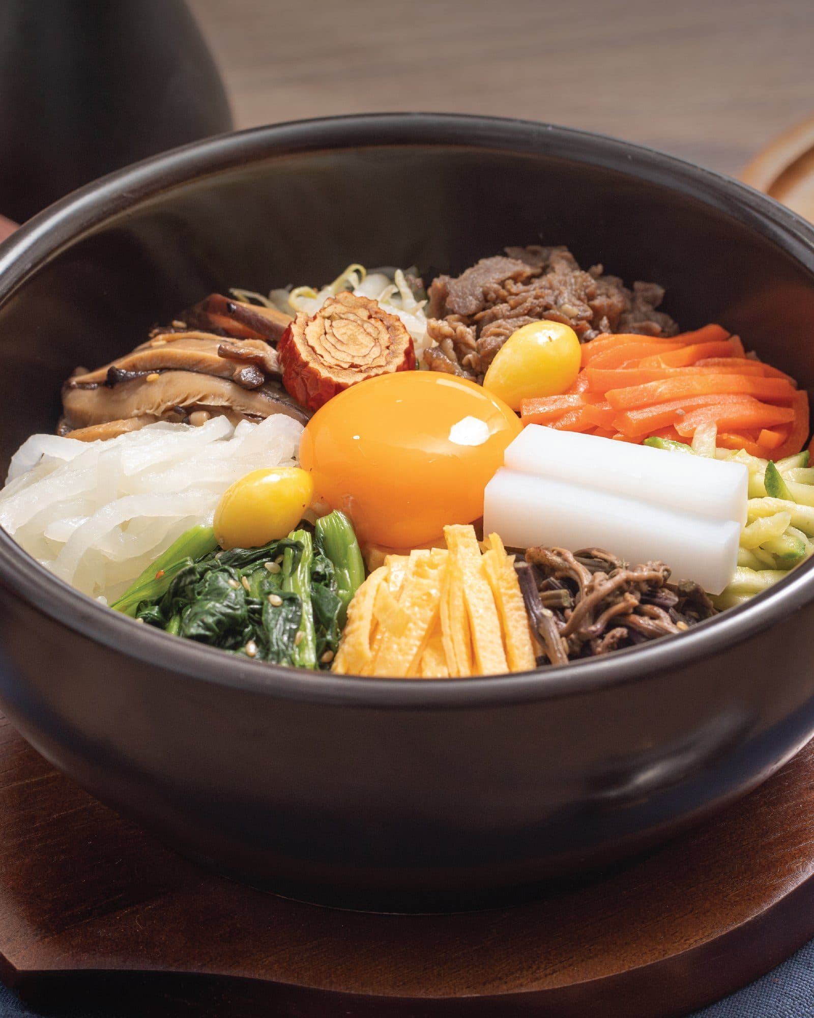 Dolsot bibimbap crowned with an egg yolk at The Bibimbab