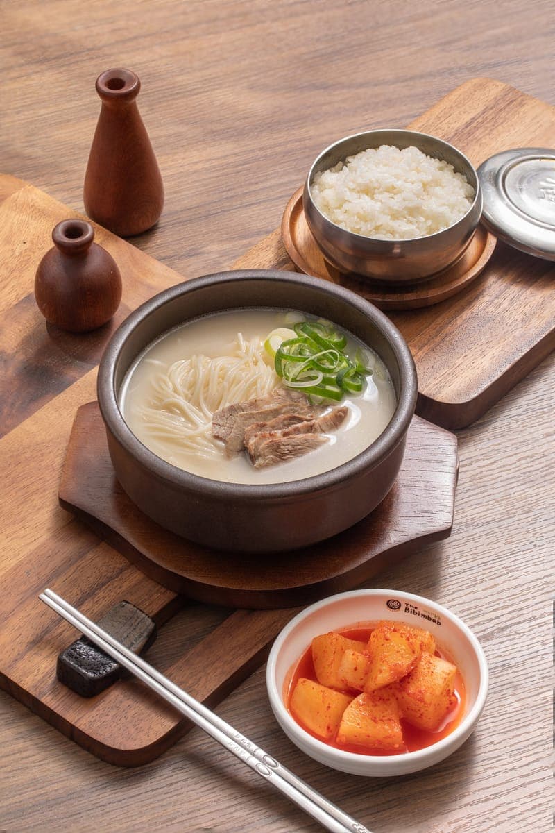 Korean soup with noodles and sliced beef, served with rice and kkakdugi